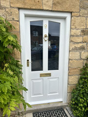 Bespoke timber front door with glazing and panels