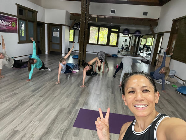 strength training class at gym — coached group workout with barbells and dumbbells