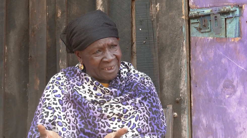 Asha Kajuju speaks to Timothy Otieno during an interview outside her house in Mjini estate.