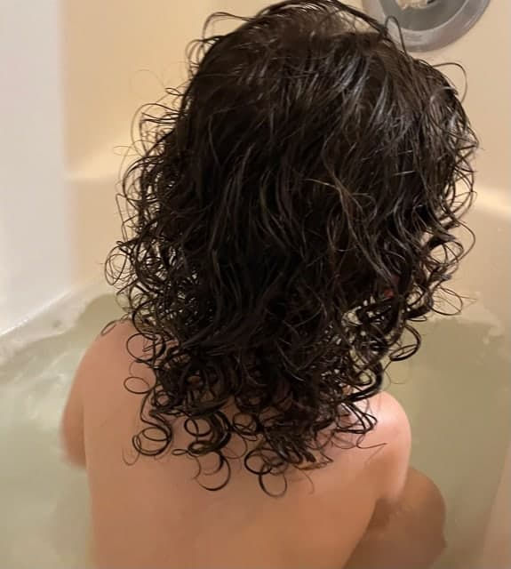 Curly hair on child in bath