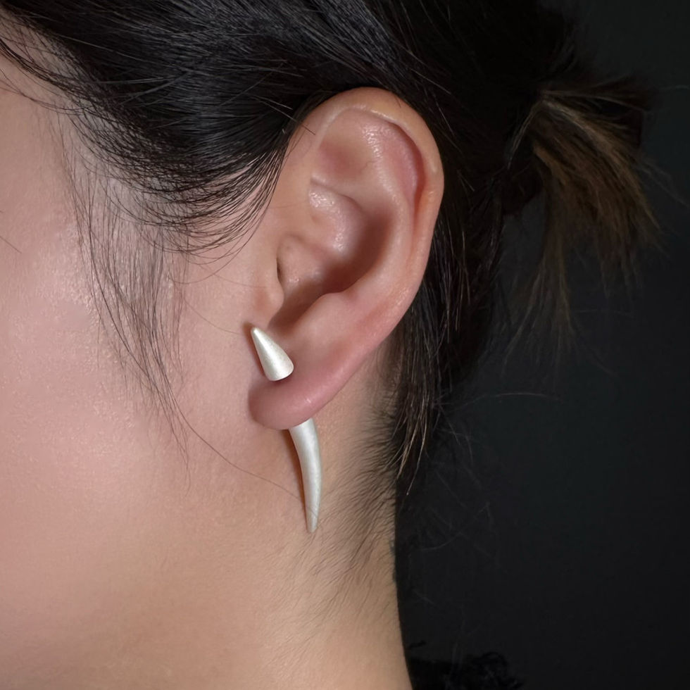 Single curved bud-inspired sterling silver earring by REBE77E, featuring a matte texture and minimalist design for versatile