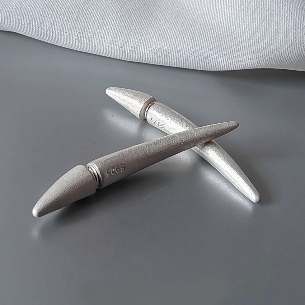 Single curved bud-inspired sterling silver earring by REBE77E, featuring a matte texture and minimalist design for versatile