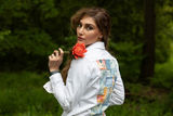 woman in white denim jacket with boro patchwork in pastels on the back panel