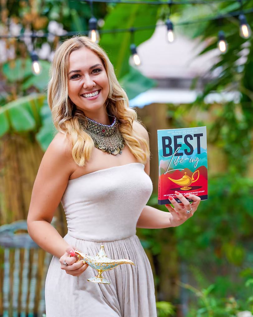 Julia Brodska holding her Best Life-ing book