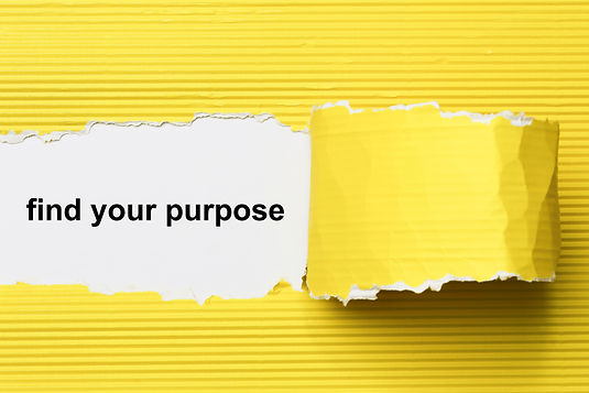Find your purpose revealed behind a ripped piece of yellow corrugated cardboard