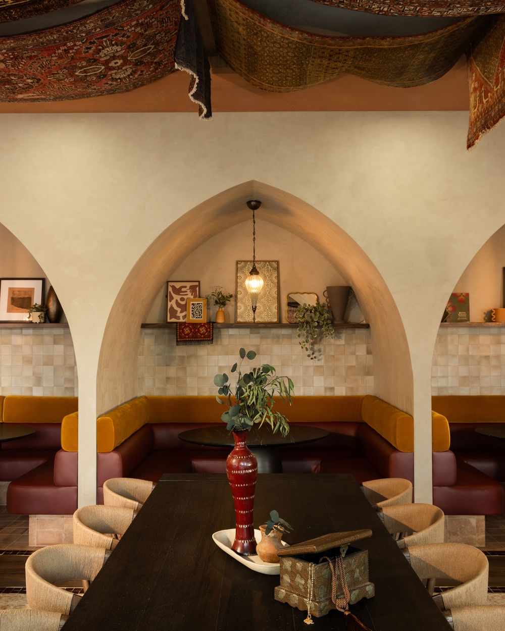 Laymoon Cafe communal dark wood table beneath rug-covered ceiling, Tempe, Arizona.