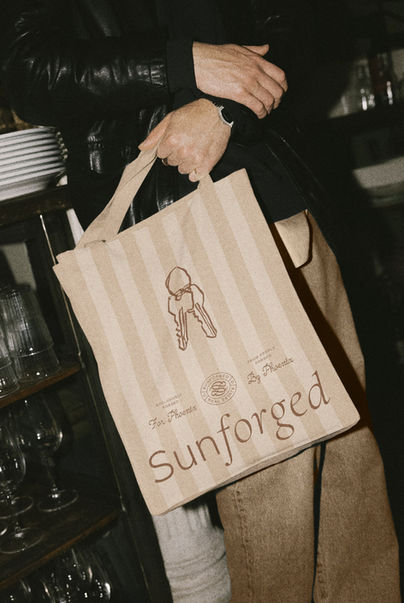 Branding, logo design, illustration, and tote bag designed by House of Form for luxury Phoenix real estate group Sunforged.