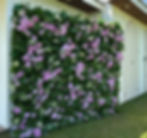 Greenery with light purple and pink roses, and small white florals throughout