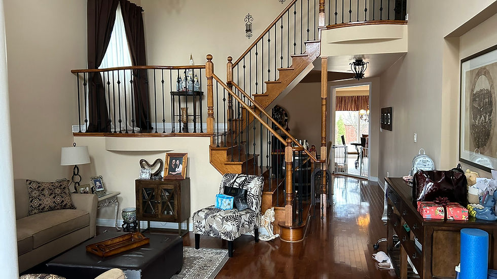 BEFORE - staircase and living room view from front door