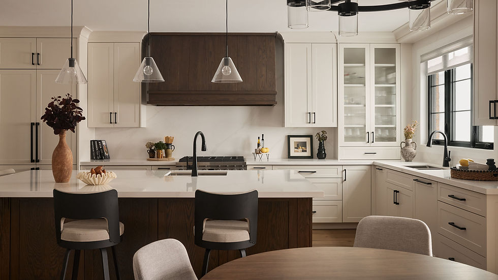 Modern kitchen with warm off-white cabinets and dark wood island and range hood. Features nine foot island with wine fridge, microwave drawer and second oven. Modern transitional kitchen design.