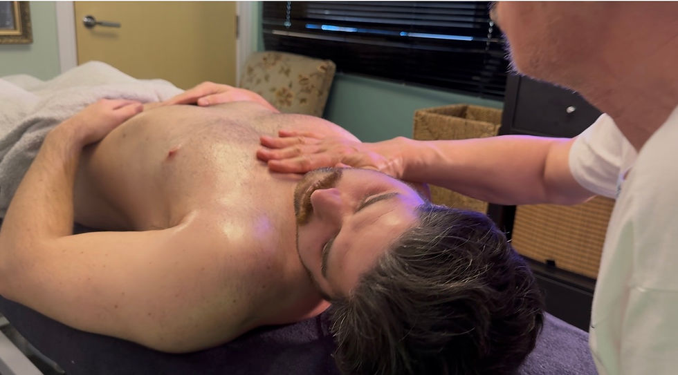 Close-up view of massage therapist applying firm pressure on back muscles