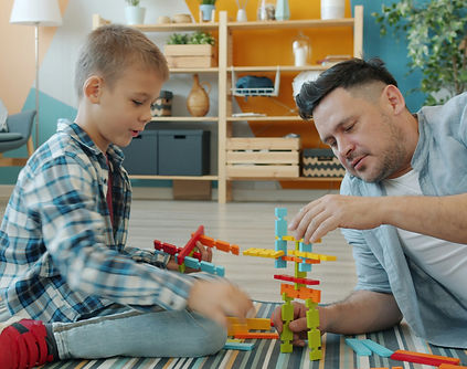 Happy kid is playing with joyful dad usi