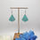 Thumbnail: Handcrafted turquoise earrings displayed on stand