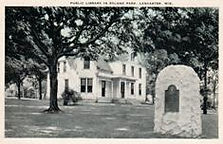 Lancaster, WI public library with stone memorial in front