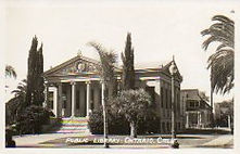 Photo postcard of the nicely landscaped Ontario, CA Carnegie library, since demolished.