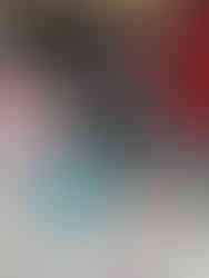 Blonde haired little boy wearing agreen checkered top is mixing a blue playd dough mixture using a wooden spoon. His face is very focused.