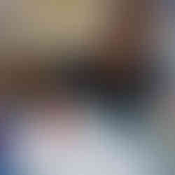 a young child is using Christmas stamps to make marks on the paper in front of him