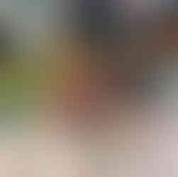 two young children smiling to the camera as they are eating marmalade sandwiched during a Paddington themed snack on World Book Day 2026 at Fun Box Day Nursery Totton