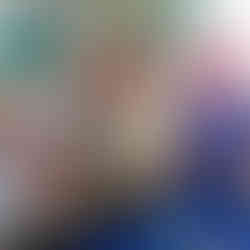 three young children trying to catch toy fish from a builders tray covered in blue paper