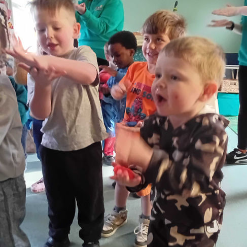 a group of young children dancing to dough disco at nursery