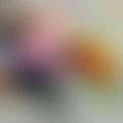 baby is sitting next to a farm toy trying to open the gates