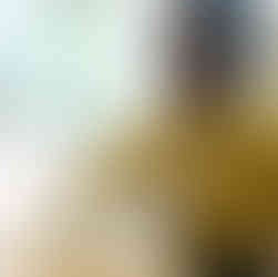 a baby boy is touching a white melleable ball on a wooden table