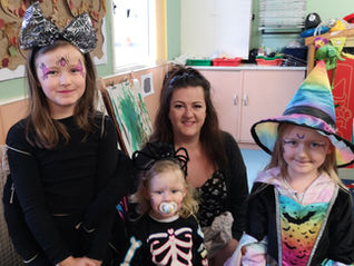 a smiling family dressed up for Halloween Workshop at Fun Box Day Nursery 2025