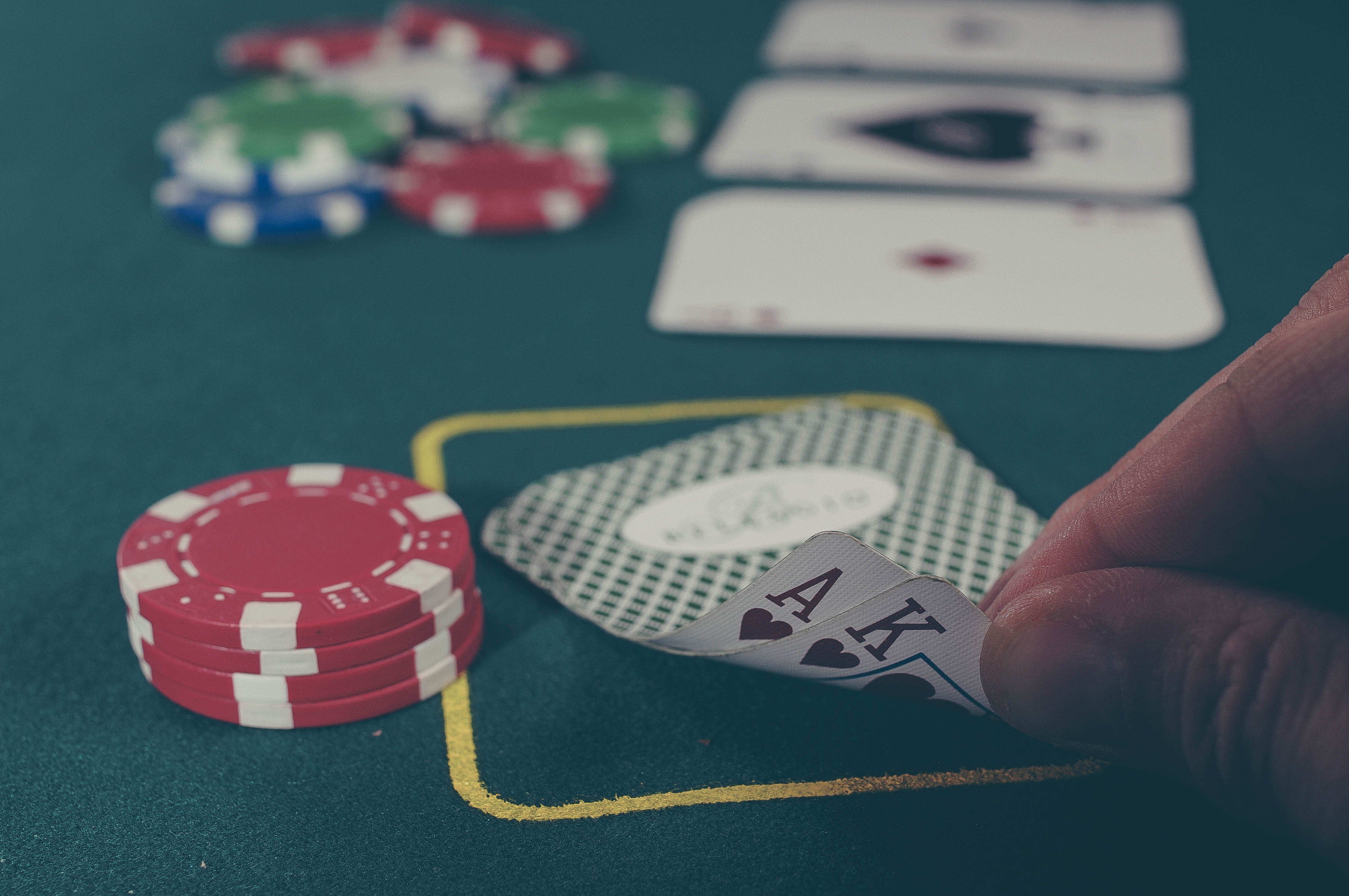 Hands holding playing cards in a poker game