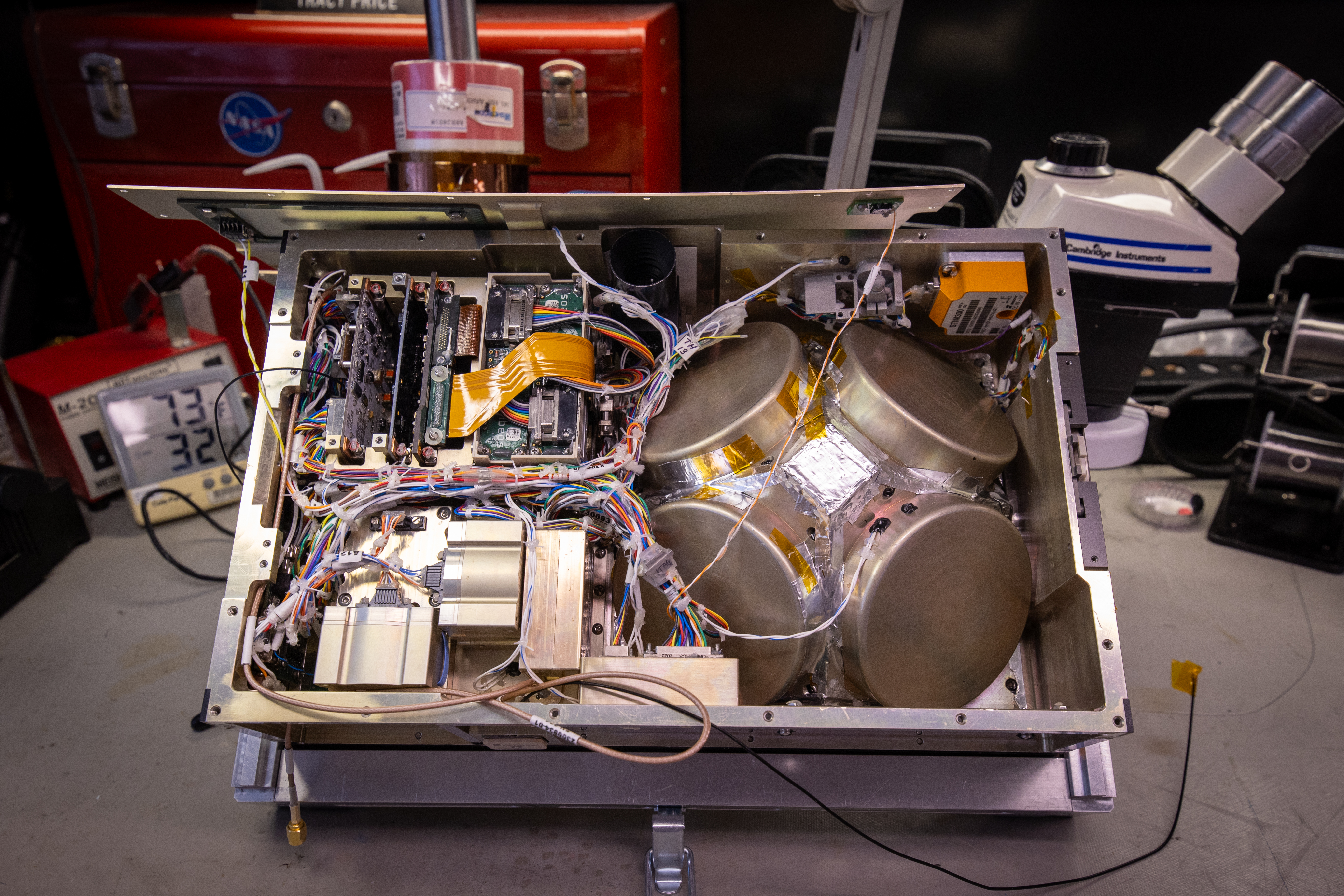 The interior components of the BurstCube satellite on a workbench