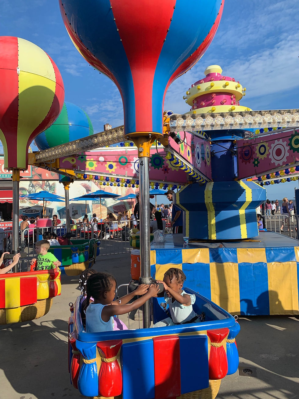 Two girls sitting on a carnival ride