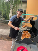 Chef Hays Bruce grilling chicken on a barbecue grill