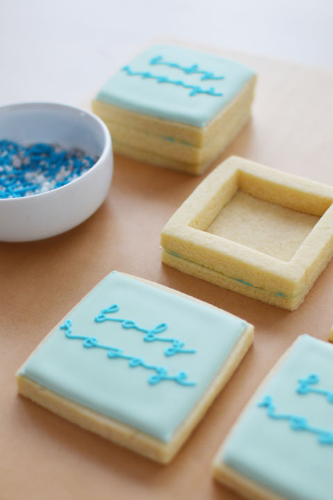 a baby shower party favor cookie with the word baby on it