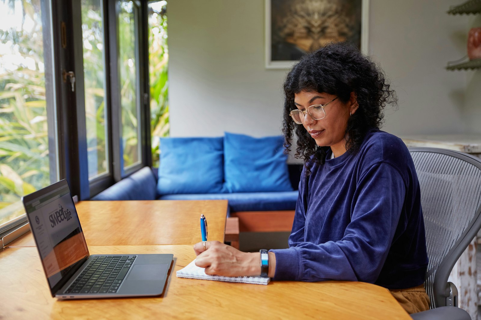 Woman filling in her profile on a laptop at home