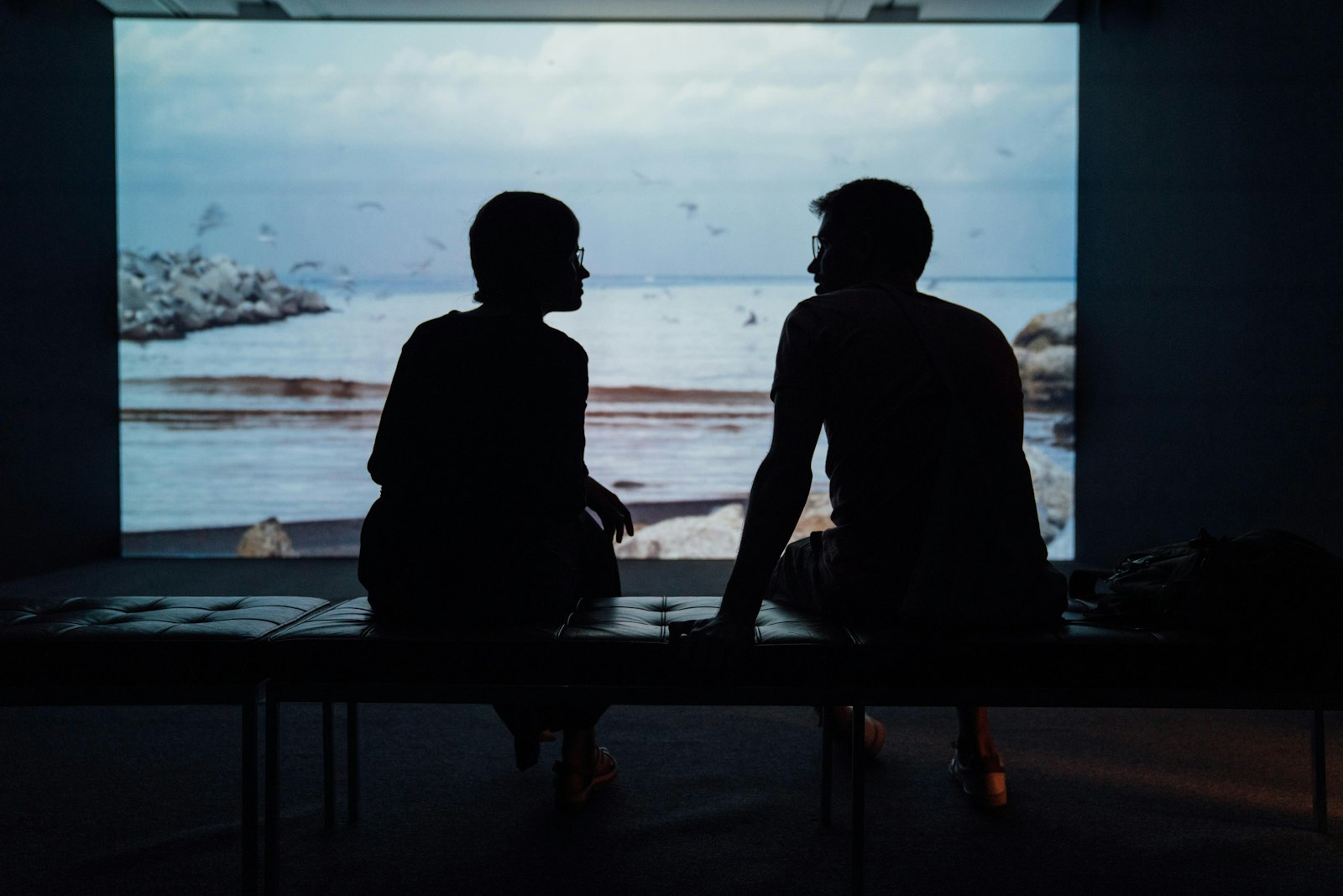 Couple sitting quietly together at home, late evening