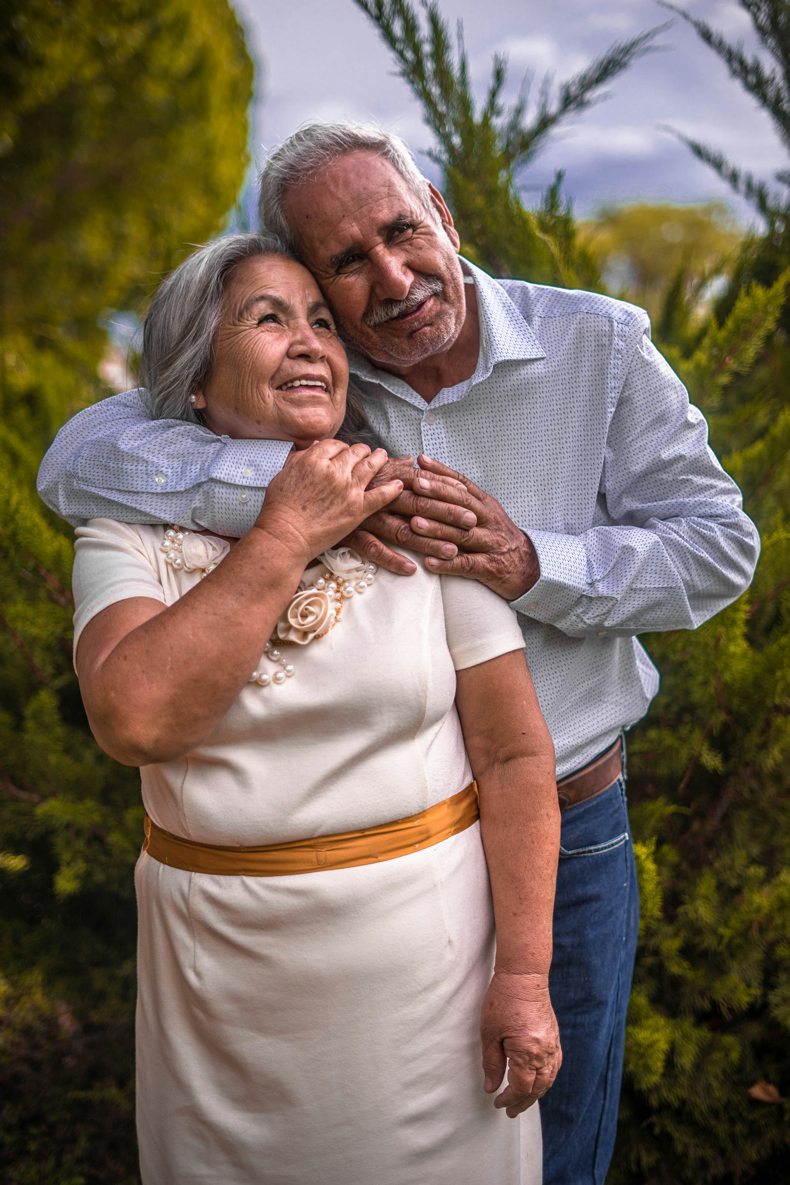 Older couple holding hands on a balcony