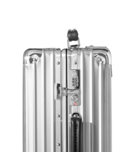 Close-up of the Rimowa Original Cabin suitcase handle and locking system, highlighting the TSA-approved lock, chrome hardware, and signature grooved aluminium shell.