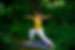 Annelie doing a warrior yoga pose in nature