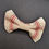 Thumbnail: A UK Made doggy bowtie, made from a cream fabric with a red window pane check. It is on a black background.