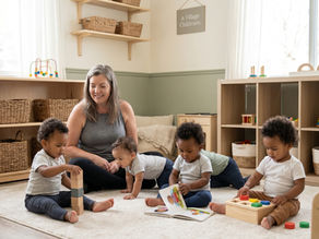 Provider observing children’s development through play in a cozy A Village Childcare home daycare room.