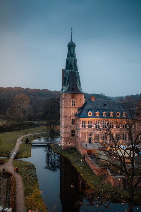 Schloss im Abendlicht, Wassergraben und Bäume