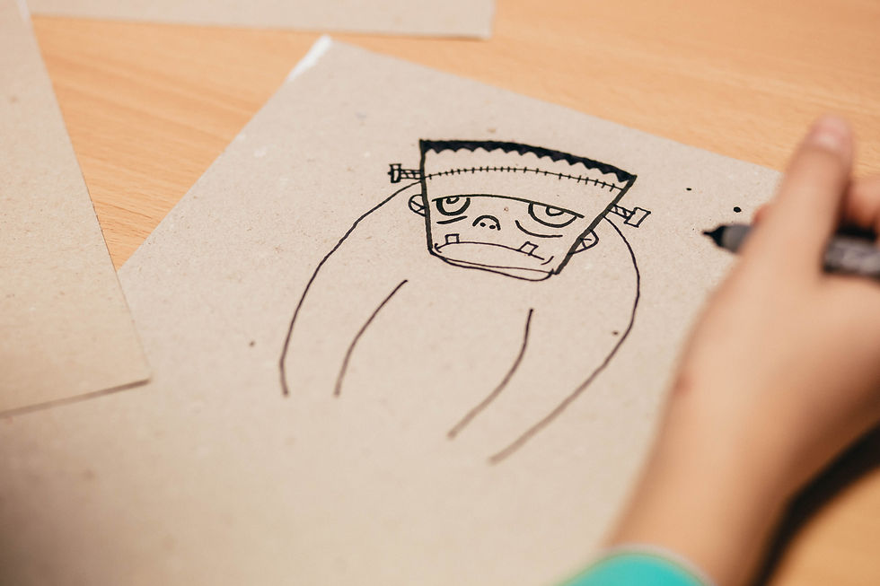 Paper and pen drawing of Frankenstein. His expression is melancholy but not menacing. The artist's hand is still hovering over the page.