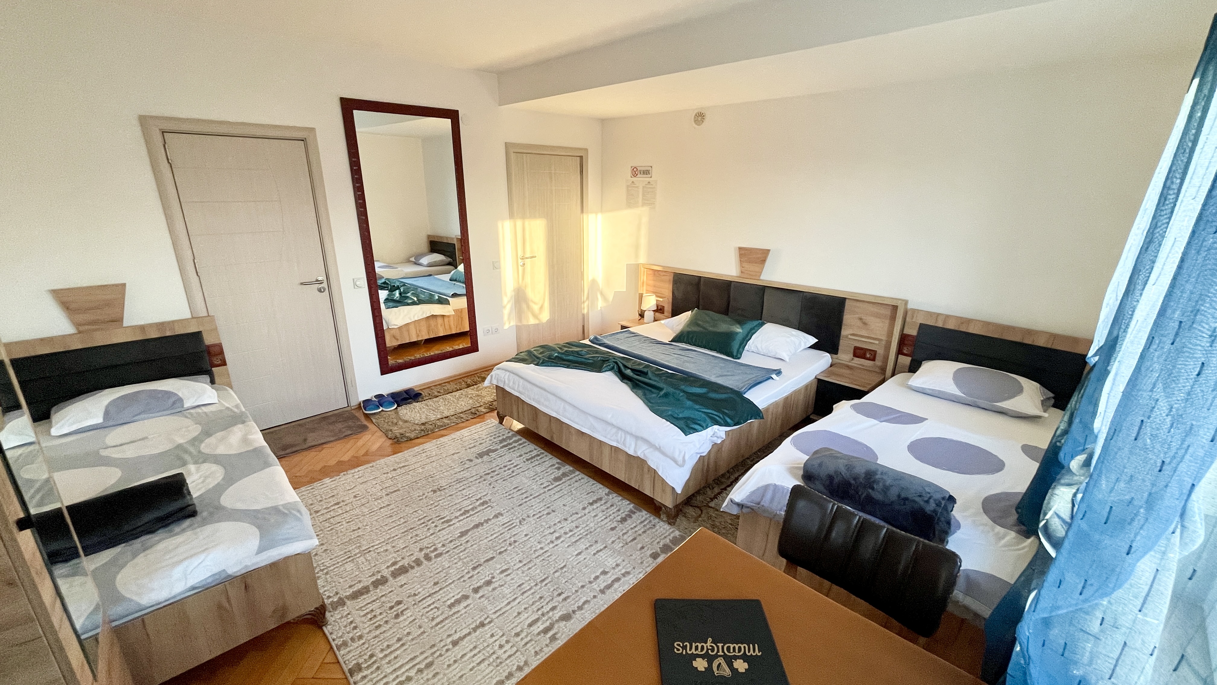 Room 104 family bedroom with a double bed and two single beds