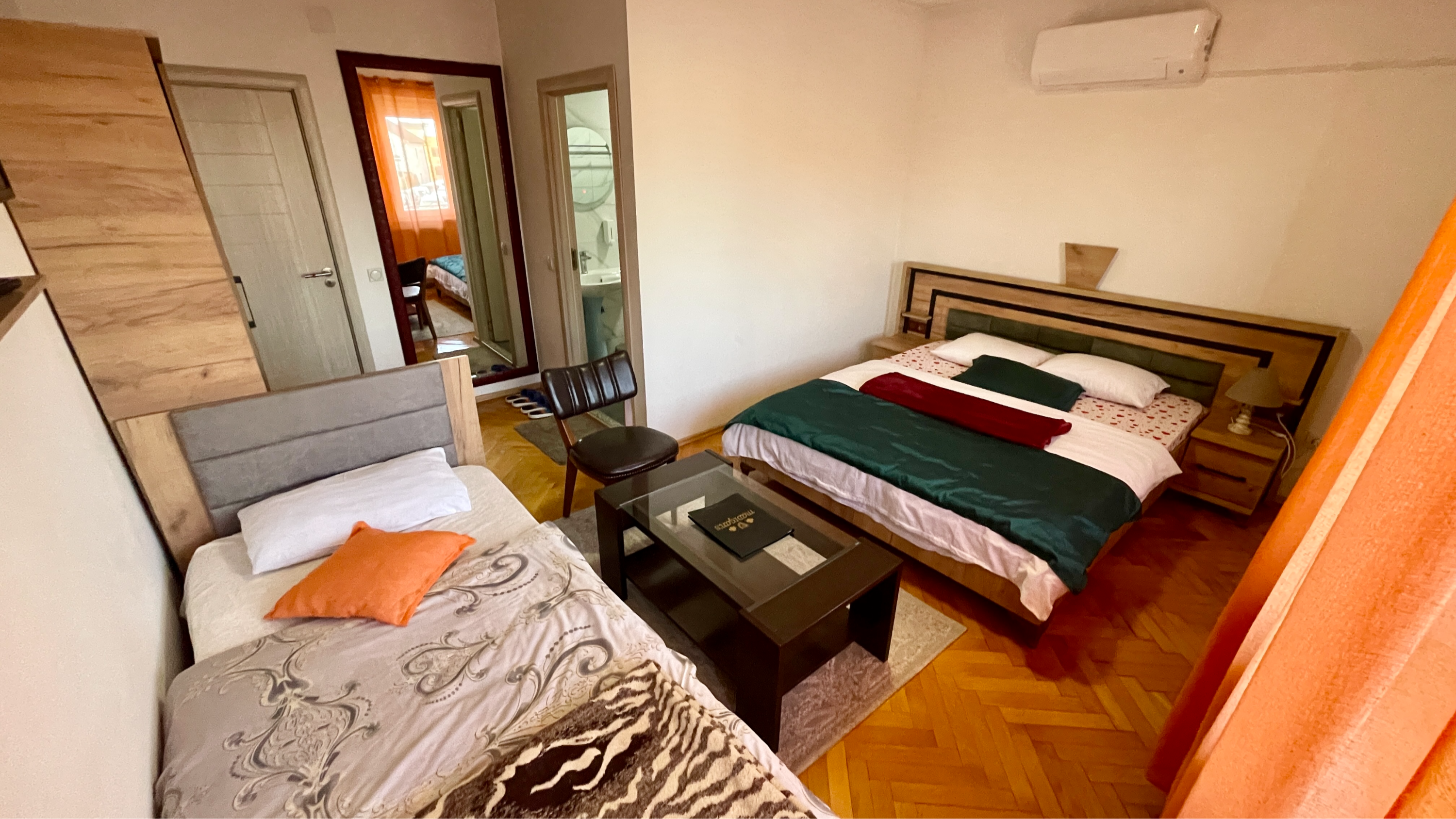 Room 102 bedroom with a double bed, single bed and seating area