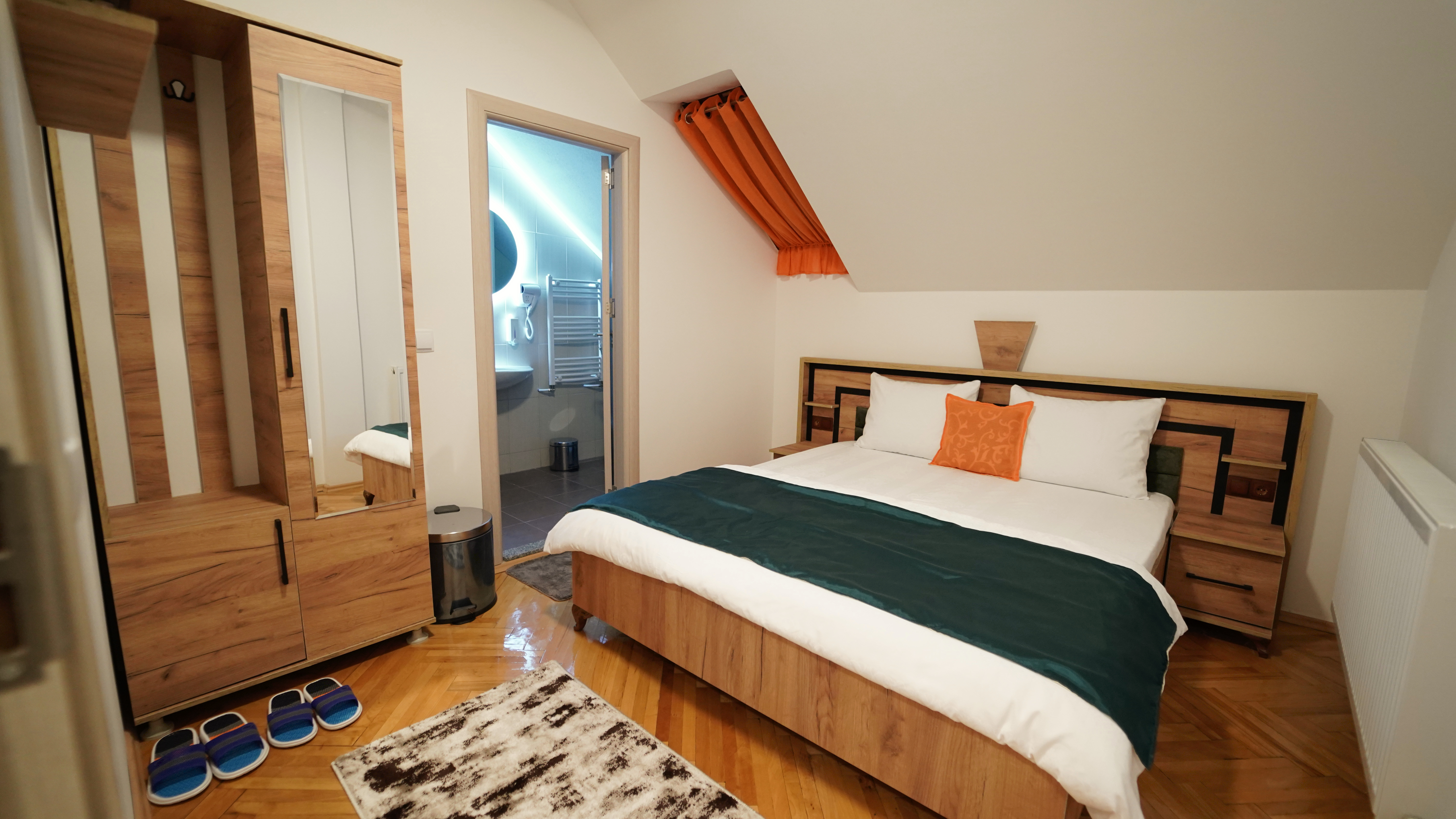 Room 203 bedroom with a double bed, bedside tables and green bedding
