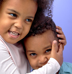 Special needs caregiver comforting a young Hamptons child experiencing separation anxiety, providing calm reassurance and emotional support in a nurturing, high-trust childcare setting.
