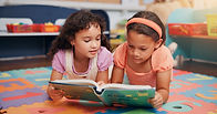 A quiet reading corner offering calm, comforting event childcare spaces where children can relax and enjoy age-appropriate books.
