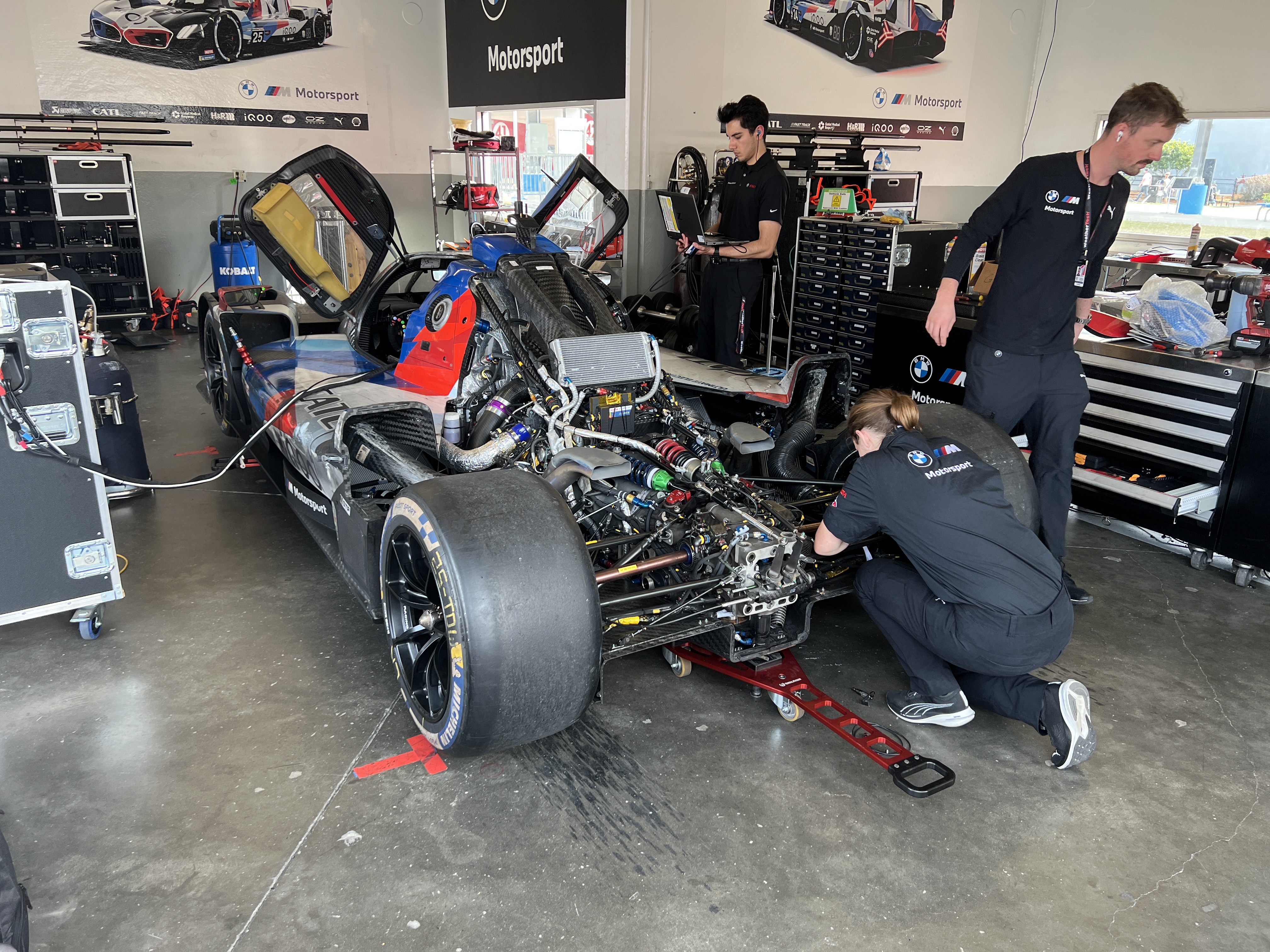 BMW LMDh car with engine cover removed.