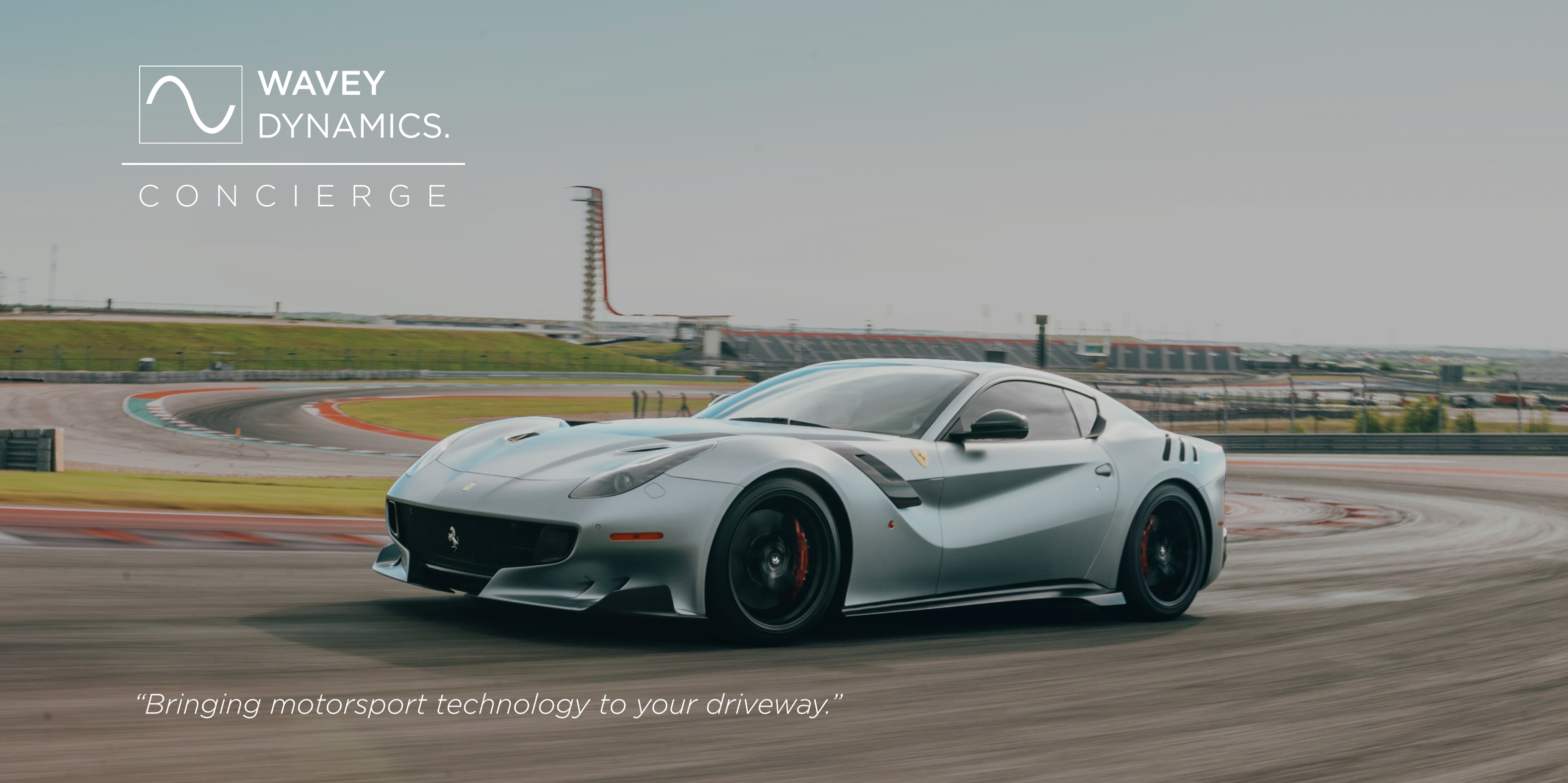 Ferrari F12 on a racing circuit with Wavey Dynamics Concierge branding — Bringing motorsport technology to your driveway