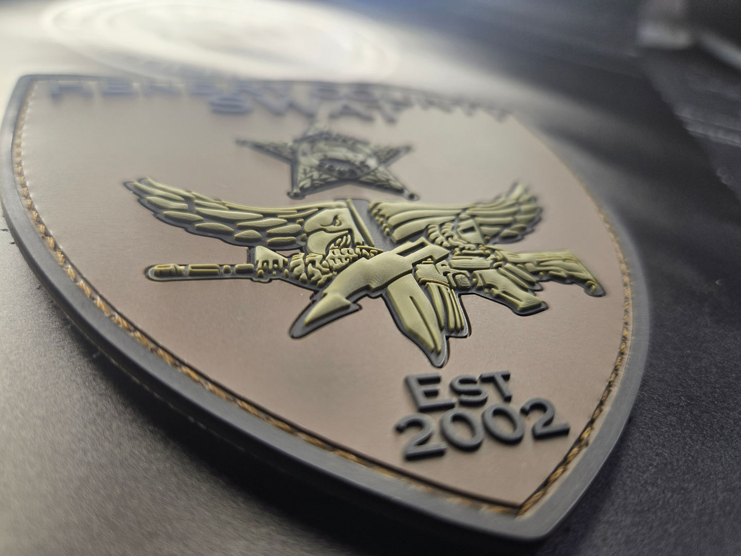 Hendry County Sheriff’s Office SWAT PVC patch, shield shape, muted tan and olive base with black and charcoal accents.