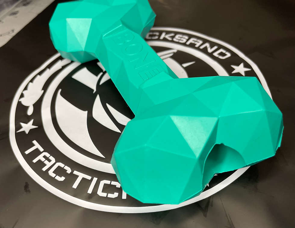 Active K9 playing with Diamond Bite Bone durable chew toy outdoors, showing strength and durability.